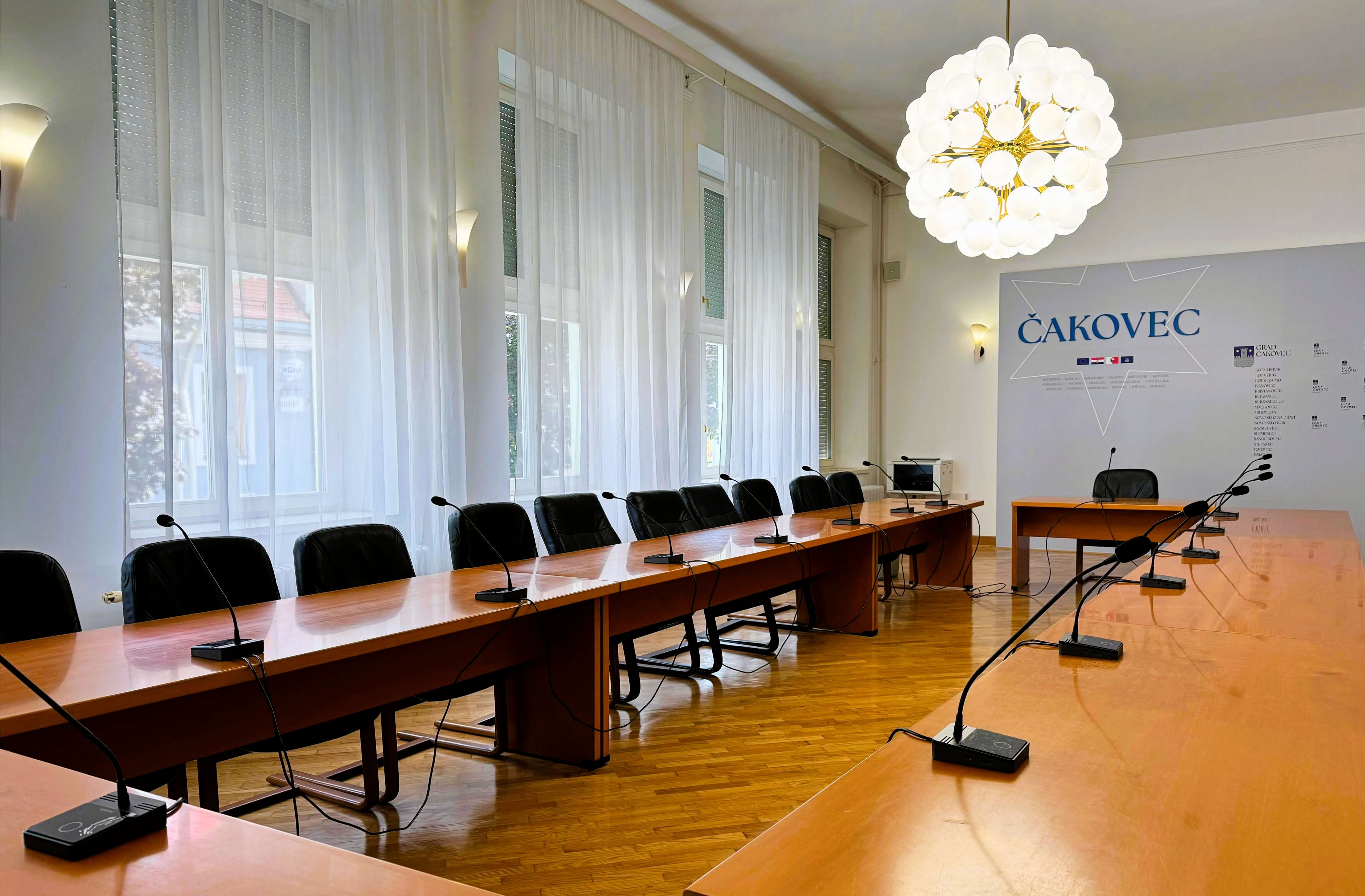 Boni pogled na konferencijsku sobu s Vissonic diskusijskim mikrofonima, centralnim DSP sustavom i bijelim rack ormarom